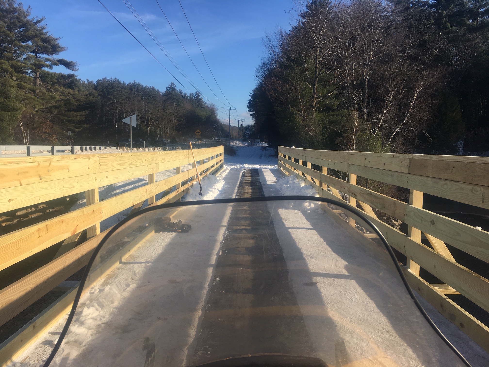 Snowmobile about to cross Lake Todd Bridge